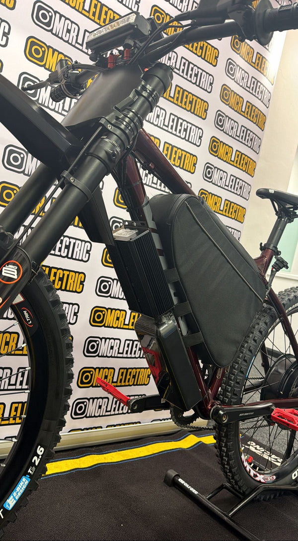 Electric bike on display with a branded backdrop